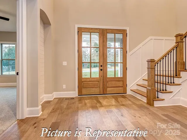 a view of an entryway with wooden floor