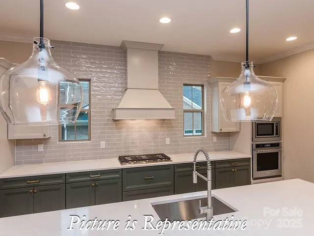 a kitchen with granite countertop a stove and a sink