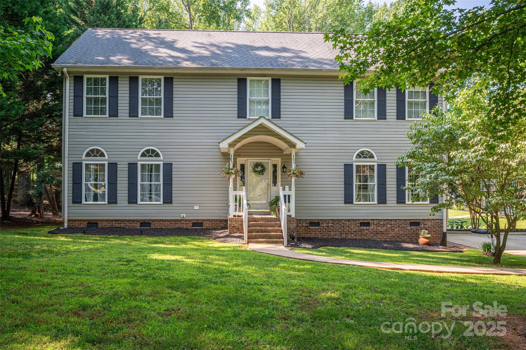 a front view of a house with a garden