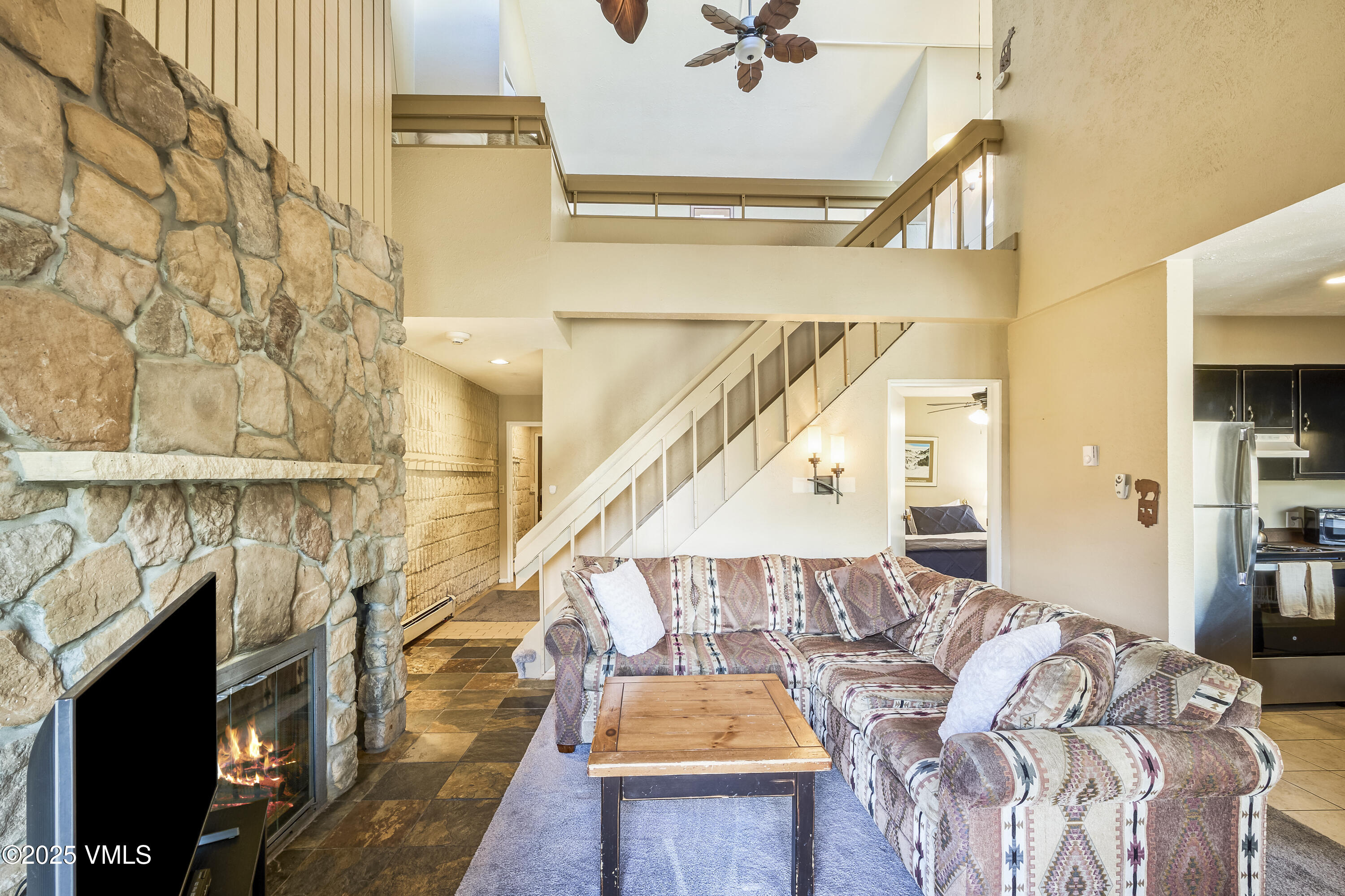 a living room with a bed and a flat screen tv
