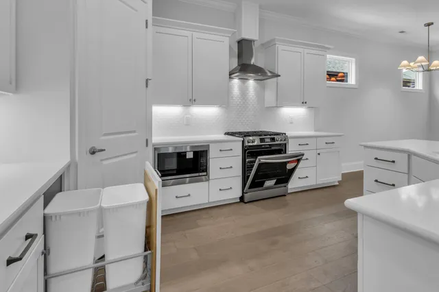 a kitchen with a sink appliances and cabinets