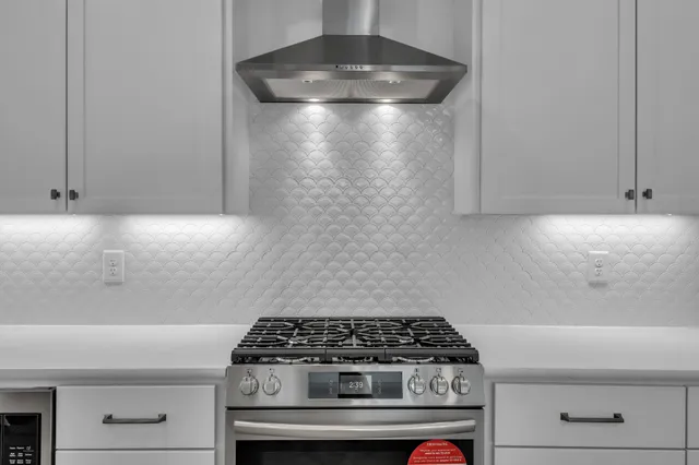 a large white kitchen with a large window