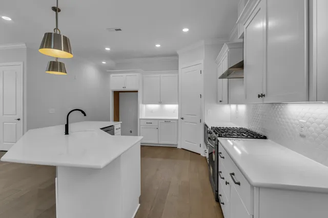 a kitchen with a sink stove and cabinets