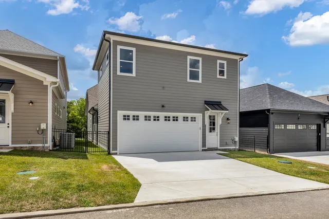 a front view of a house with yard and mountain view