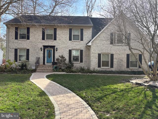 400 Willards Way Yorktown, VA 23693 - Photo 2 of 8 a front view of a house with a garden