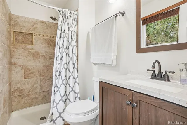 a living room with lots of furniture and a wooden floor