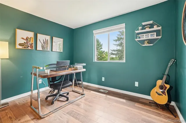 a view of a dining room with a table and chairs