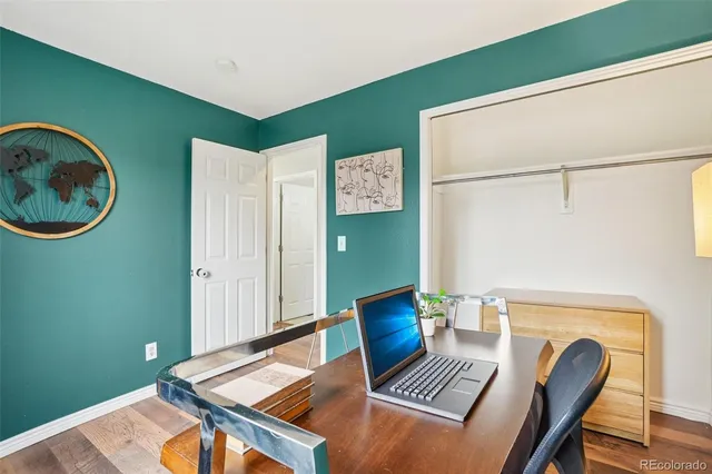 a bathroom with a granite countertop sink mirror vanity and toilet