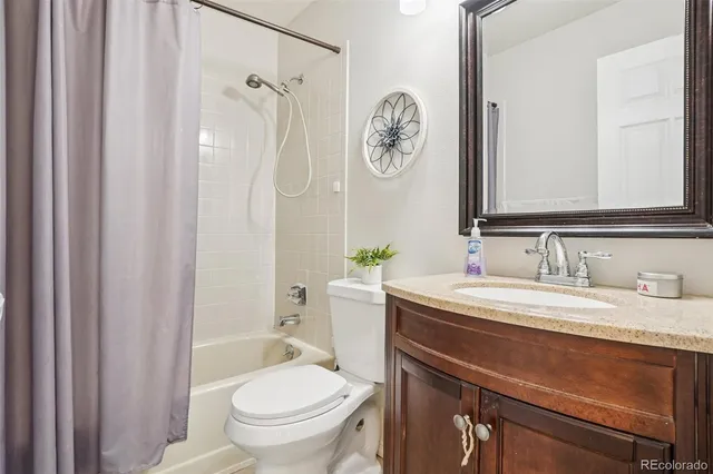 a view of a room with wooden floor fan and windows