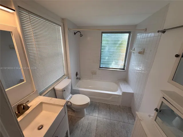 a bathroom with a sink a bathtub and a toilet