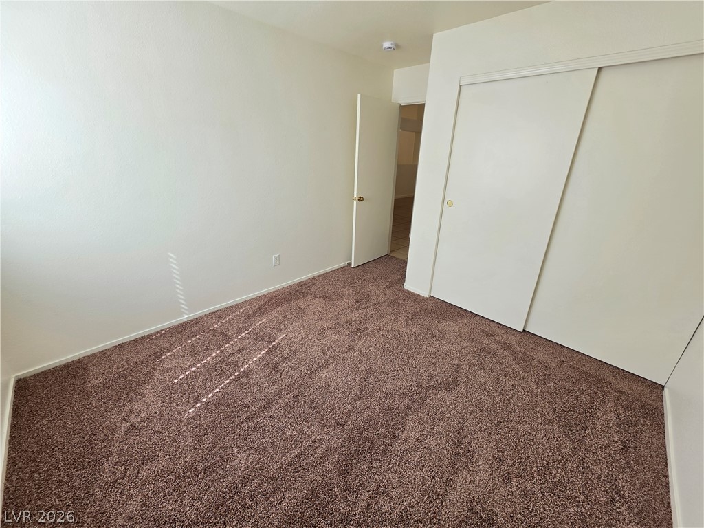 9609 Crystal Ridge Road Las Vegas, NV 89123 - Photo 12 of 21 Plush wall-to-wall carpeting and sliding closet doors define this functional bedroom space.