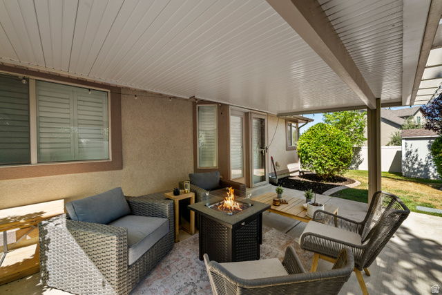 564 Spring Meadow Lane Farmington, UT 84025 - Photo 31 of 31 Covered patio with a fire pit feature, direct exterior access, and a concrete patio surface