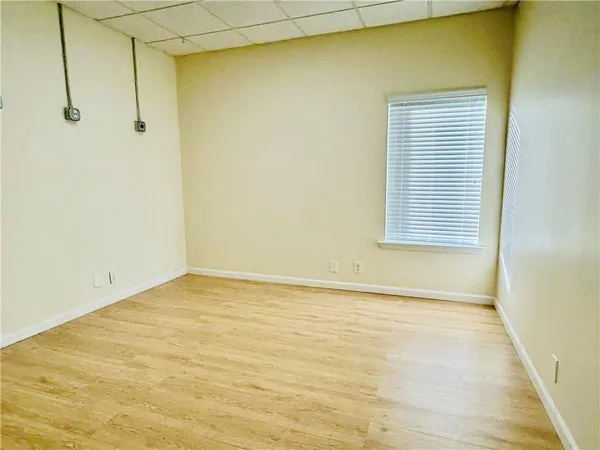a view of a room with a wooden floor and a window