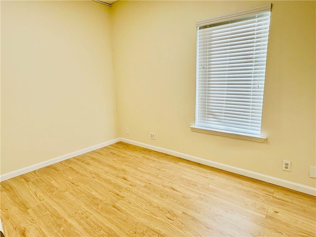 3982 Cherokee Trail Suwanee, GA 30024 - Photo 10 of 11 a view of an empty room with wooden floor and a window