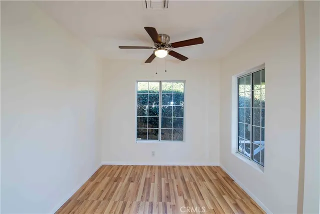 a view of a room with a window and wooden floor