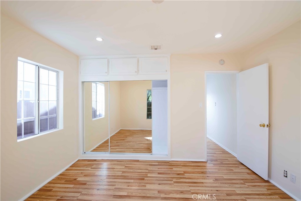 6417 White Oak Avenue Reseda, CA 91335 - Photo 19 of 50 a view of an empty room with wooden floor and a window