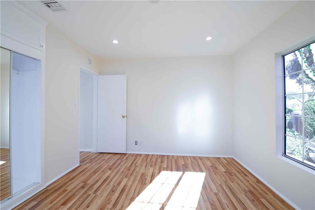 6417 White Oak Avenue Reseda, CA 91335 - Photo 20 of 50 an empty room with wooden floor and windows