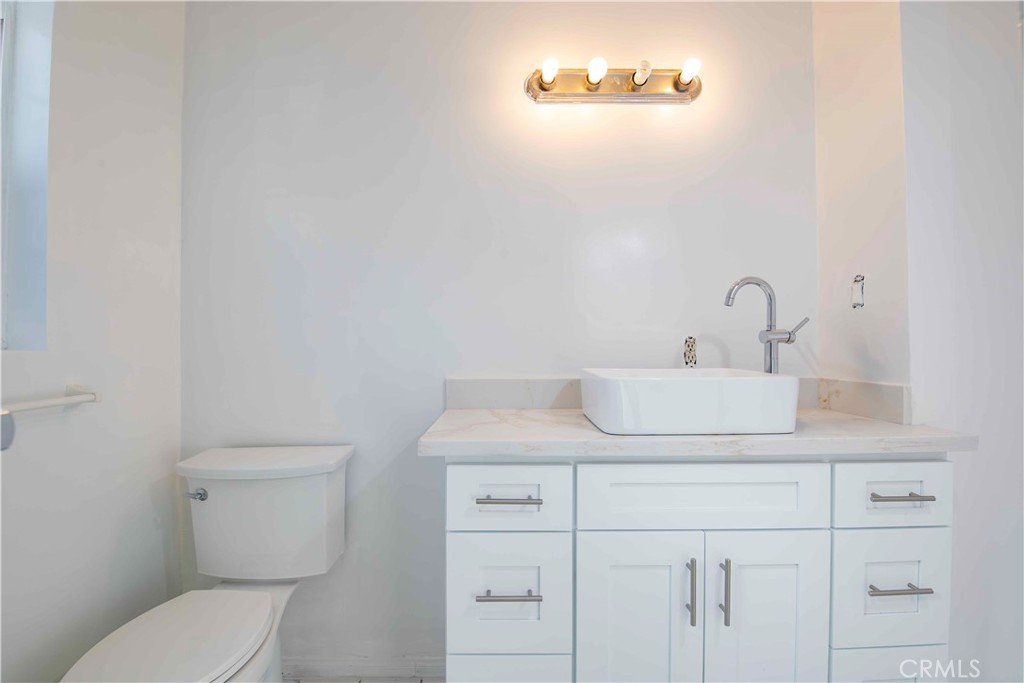 6417 White Oak Avenue Reseda, CA 91335 - Photo 22 of 50 a bathroom with a toilet sink and mirror