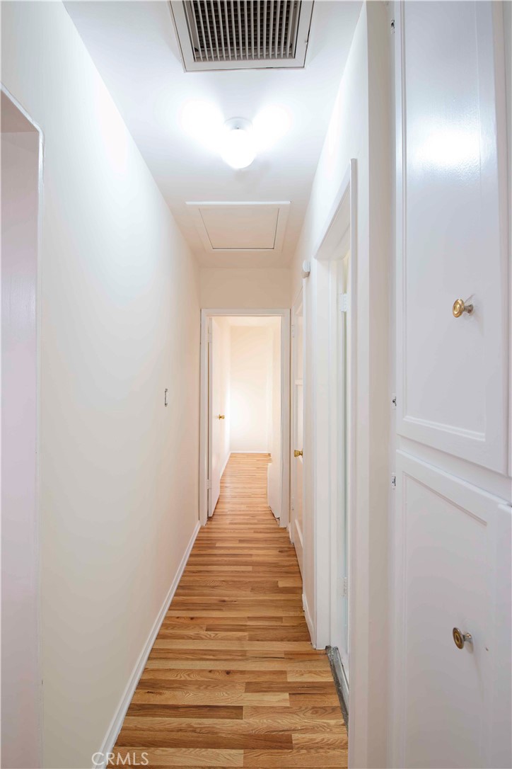 6417 White Oak Avenue Reseda, CA 91335 - Photo 27 of 50 a view of a hallway with wooden floor and stairs