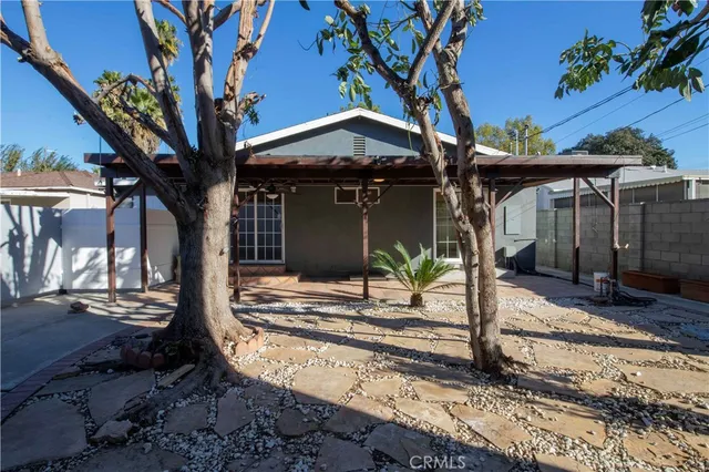 a view of a house with a tree in the yard