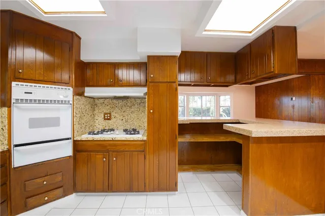 a kitchen with granite countertop cabinets and window