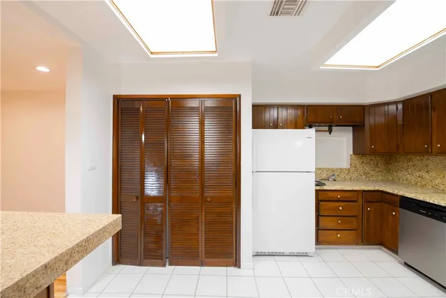 a kitchen with stainless steel appliances granite countertop a refrigerator and a sink