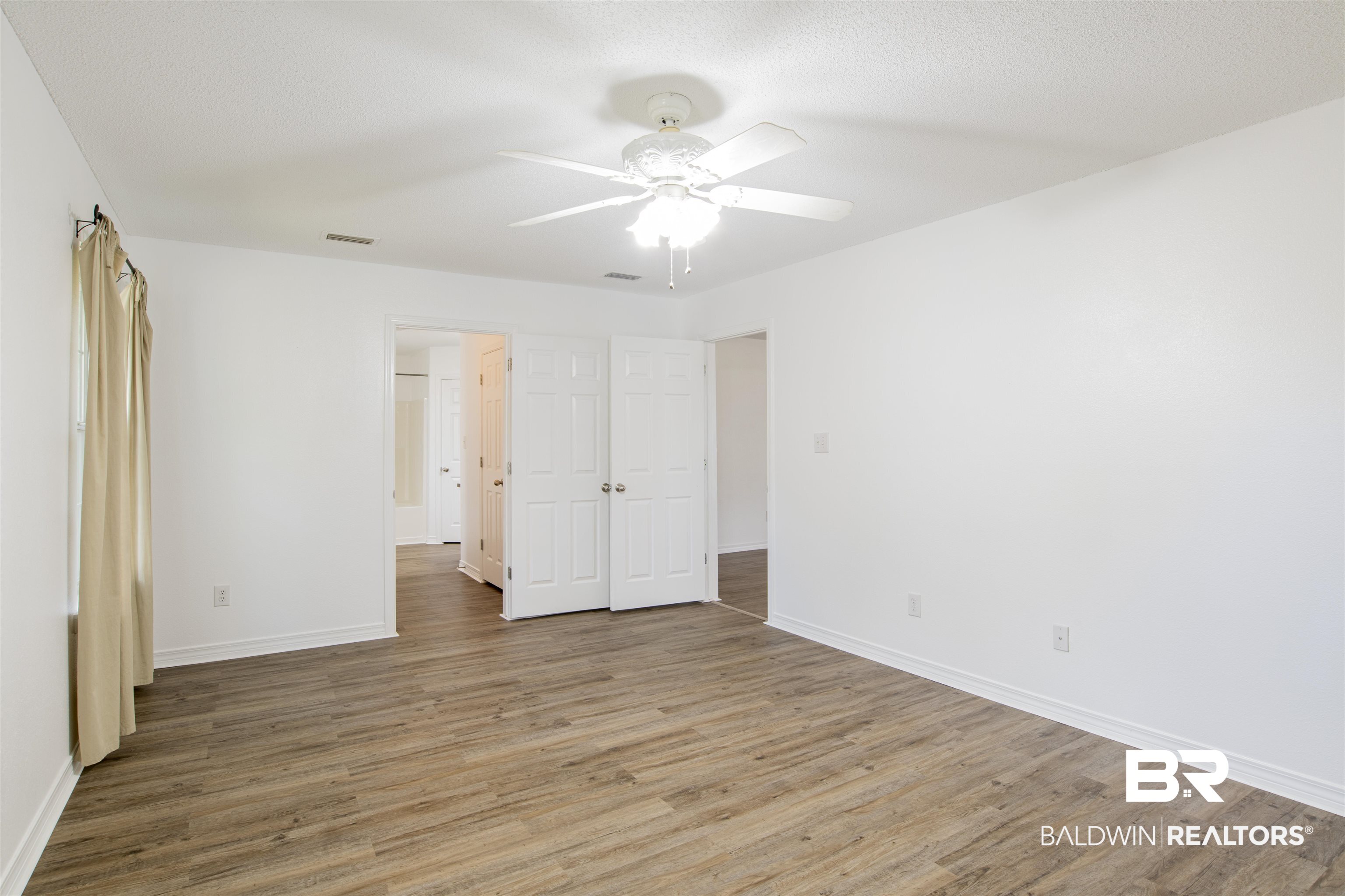 165 Pemberton Loop Fairhope, AL 36532 - Photo 18 of 25 Unfurnished bedroom with baseboards, visible vents, a textured ceiling, and wood finished floors