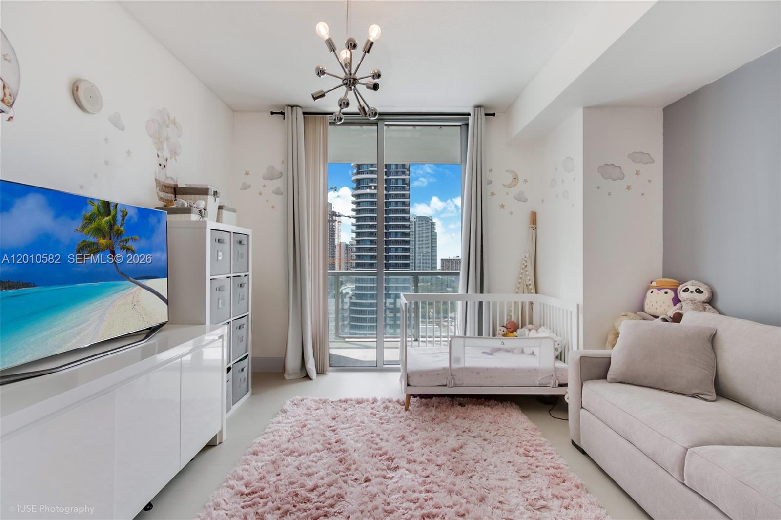79 Southwest 12th Street, Unit 2306S Miami, FL 33130 - Photo 16 of 38 a living room with furniture and a chandelier