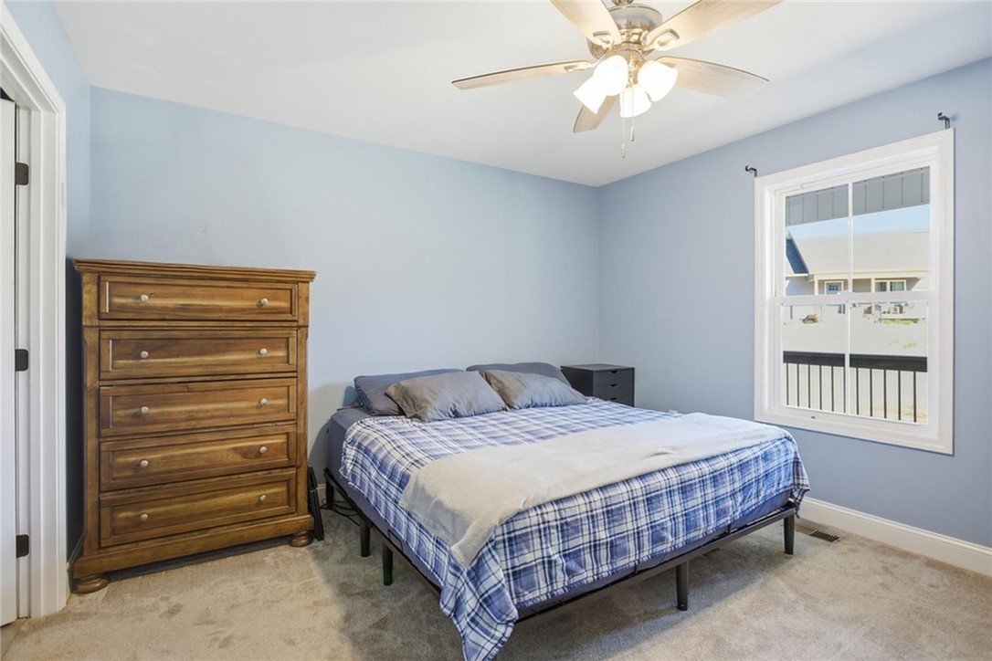 745 Dave Nix Road Seneca, SC 29678 - Photo 11 of 23 A well-lit bedroom offering a cozy retreat with a large window and soft carpeting.