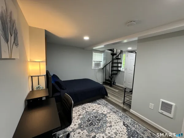 a bedroom with a bed and a window
