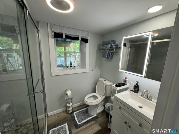 a bathroom with a toilet sink and mirror
