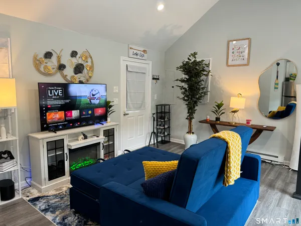 a living room with furniture and a flat screen tv