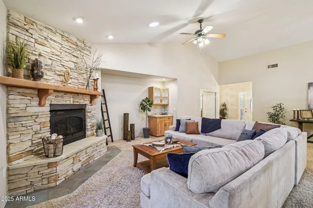a living room with furniture and a fireplace