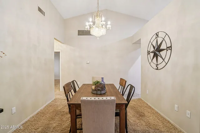 a view of a dining room with furniture and chandelier