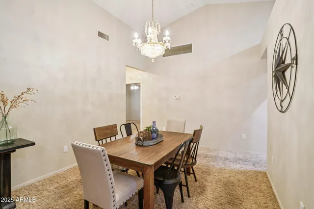a view of a dining room with furniture and chandelier