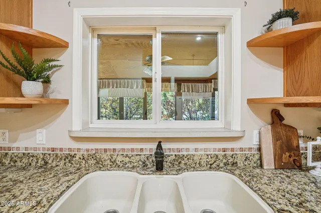a kitchen with stainless steel appliances granite countertop a sink stove and cabinets