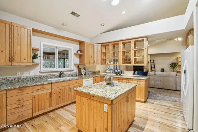 a kitchen with granite countertop cabinets and appliances
