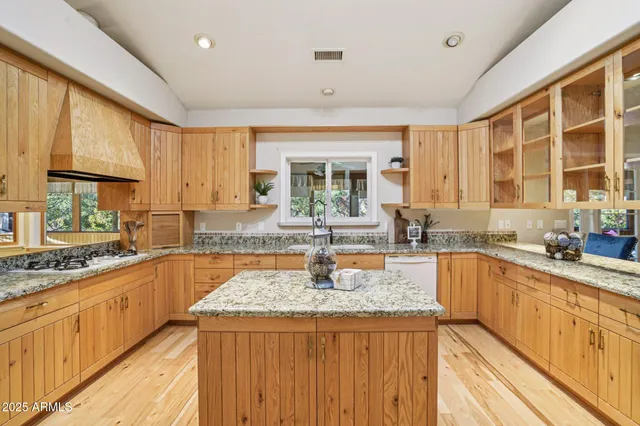 a view of a storage and utility room with wooden floor