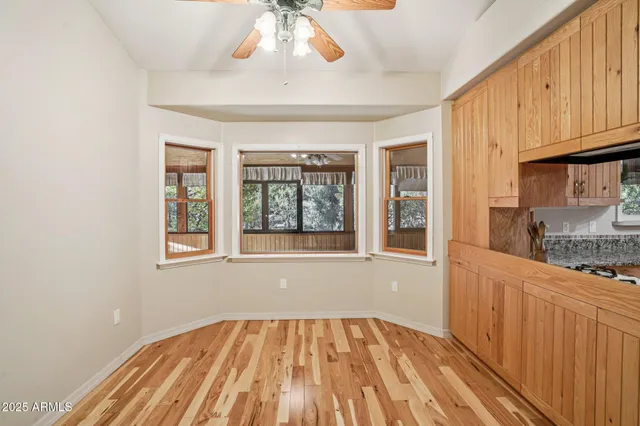 an empty room with closet and a ceiling fan