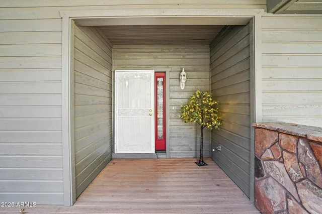 a view of a house with a small yard and wooden fence
