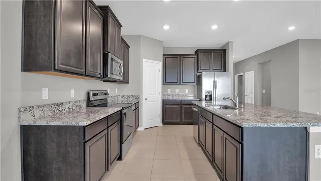 a kitchen with stainless steel appliances granite countertop counter space cabinets a sink and a counter top space