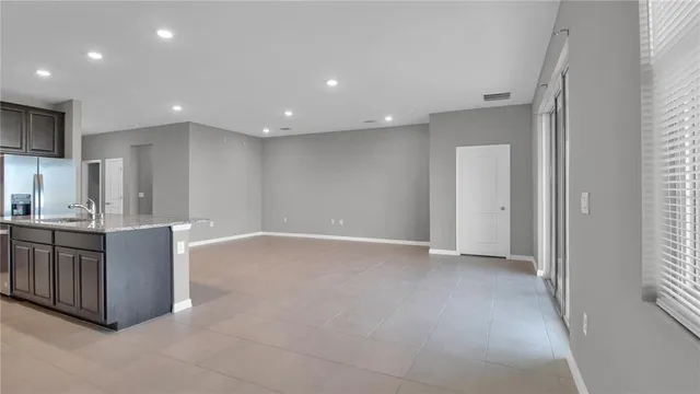 a view of kitchen with stainless steel appliances cabinets and outdoor space