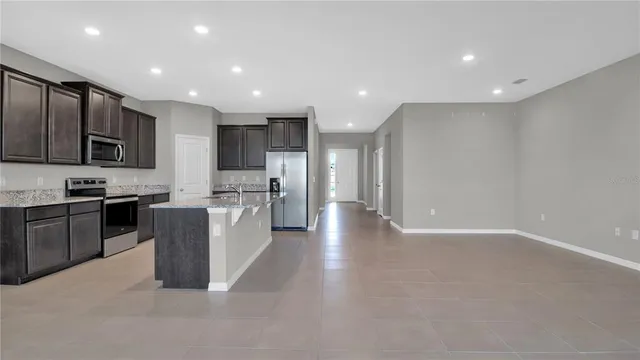 a large kitchen with stainless steel appliances lots of counter top space