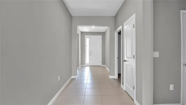 a view of a hallway with wooden shelves