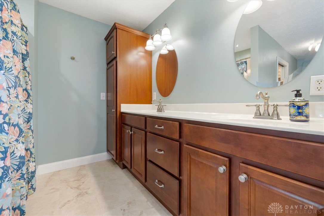 841 Willow Road Springfield, OH 45502 - Photo 22 of 64 This bright bathroom offers ample storage, dual vanities, and a clean, serene aesthetic.