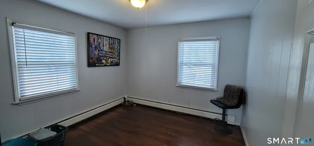 a living room with furniture a dining table and a window