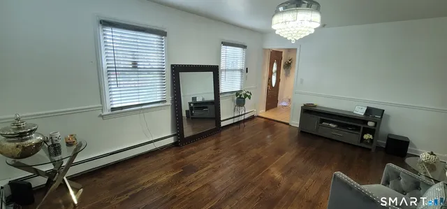 a living room with furniture and a chandelier