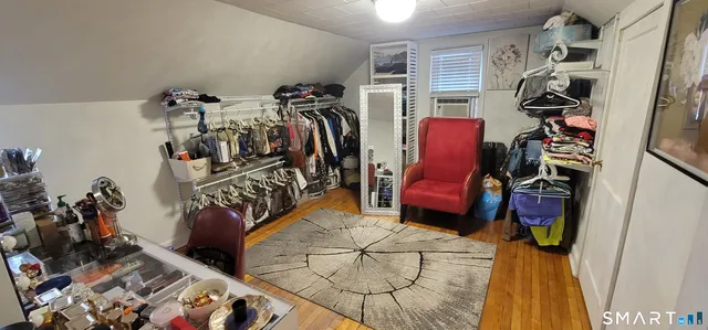 a view of walk in closet with clothes