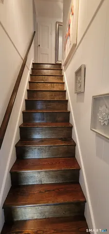 a bedroom with furniture and a flat screen tv