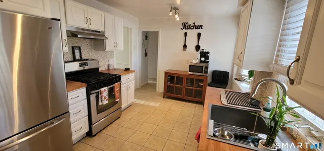 a kitchen with a refrigerator and a sink